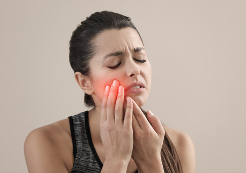 Young woman suffering from acute toothache